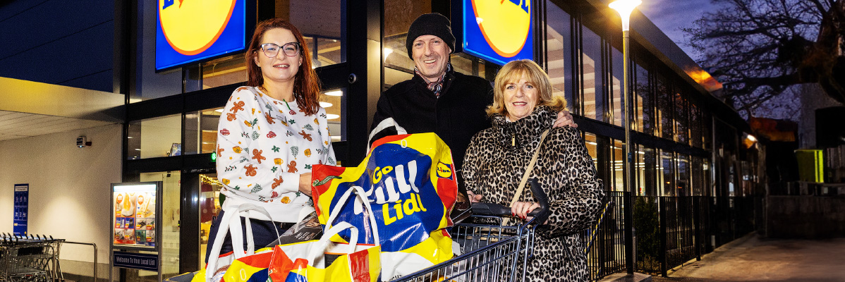 Lidl bags and customers outside a Lidl store.