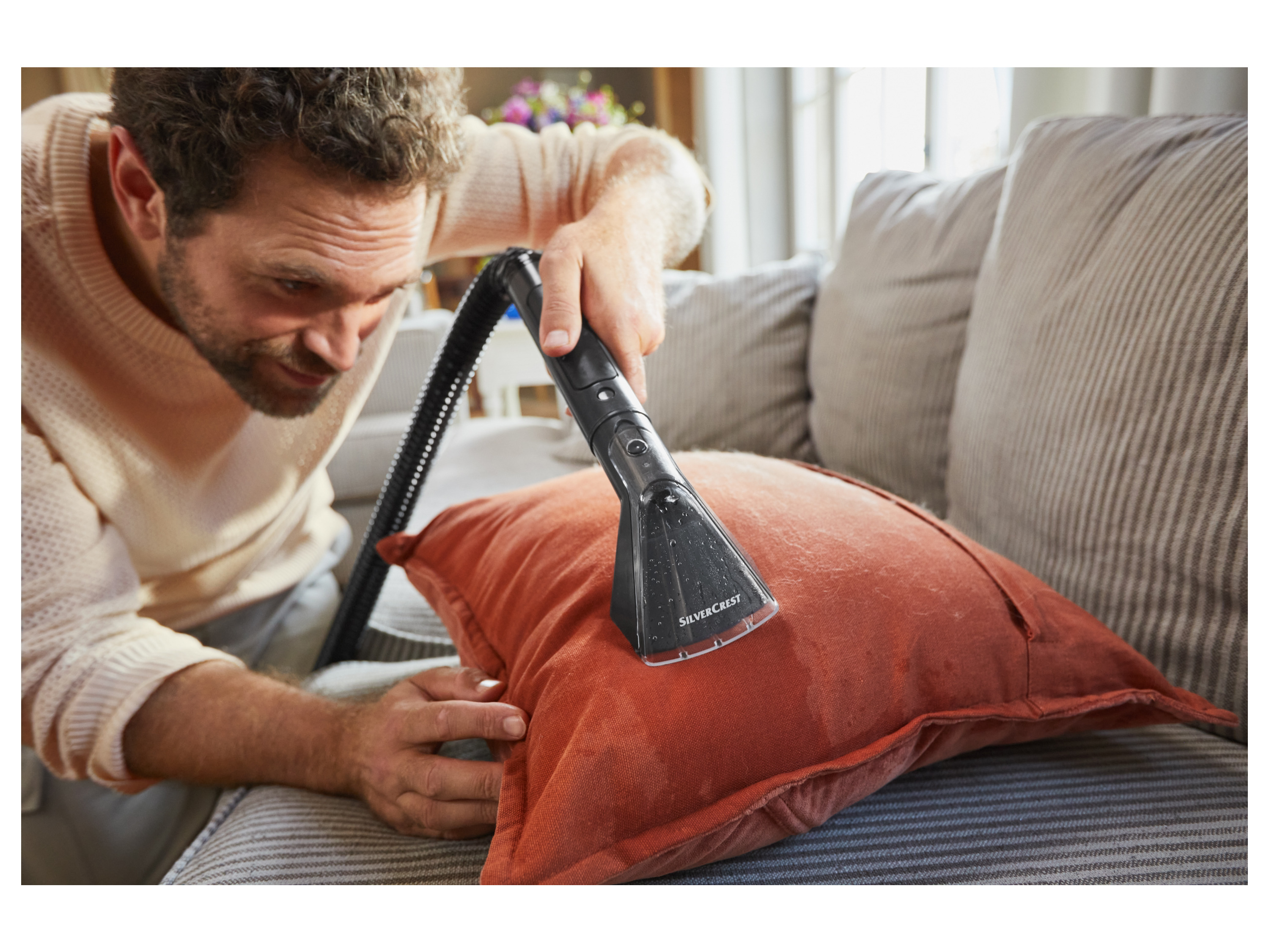 Cleaning cushions with a Silvercrest cleaner.