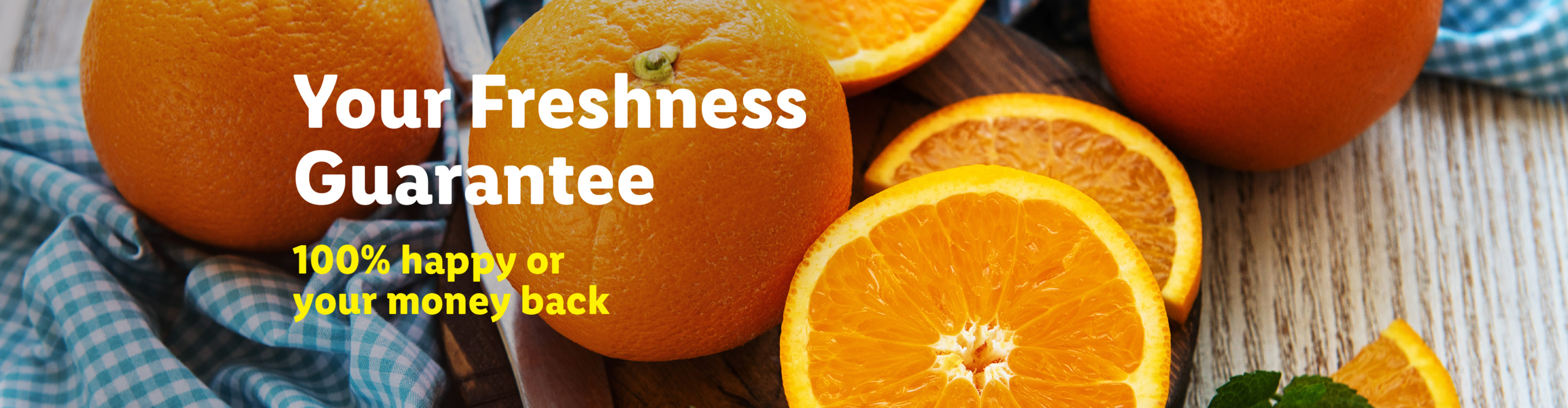 Fresh oranges, whole and sliced, with text: Your Freshness Guarantee, 100% happy or your money back.