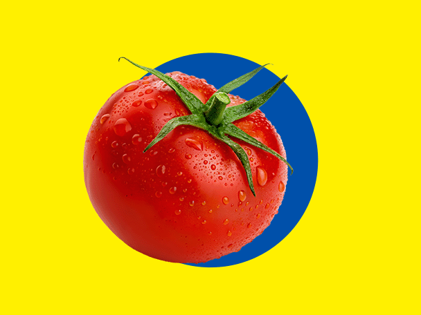 A fresh red tomato with water droplets, on a yellow background with a blue circle.