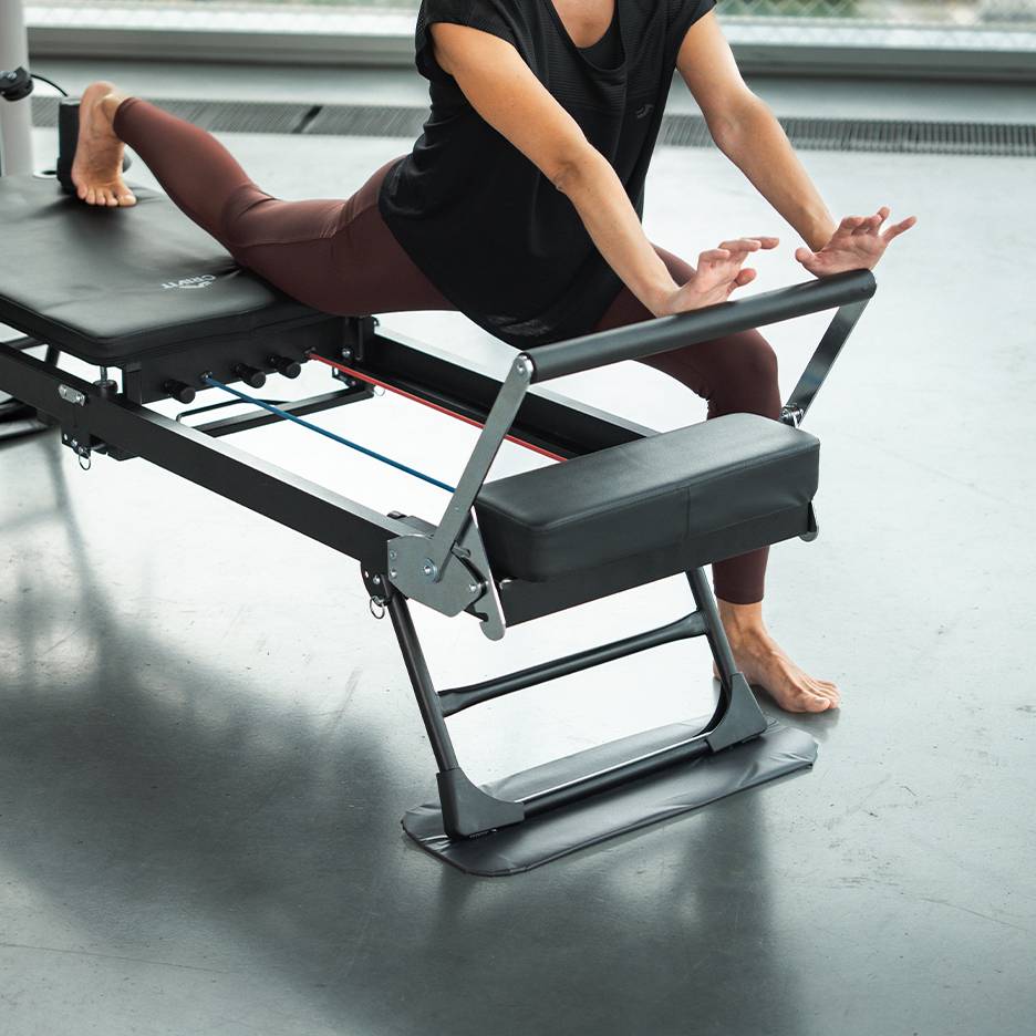 Woman exercising on a Pilates machine in sportswear