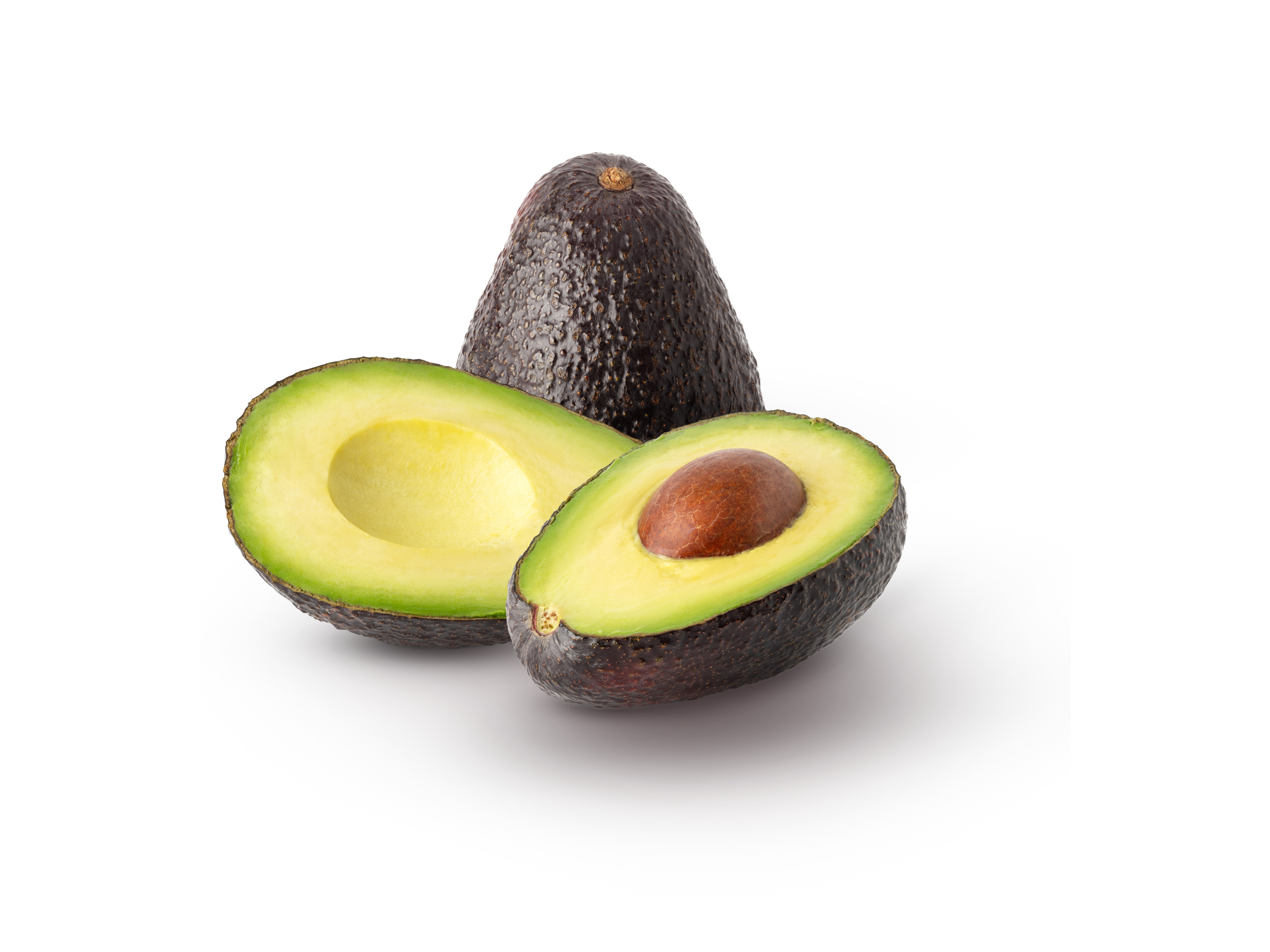 Whole and halved ripe avocados with a visible pit on a white background.