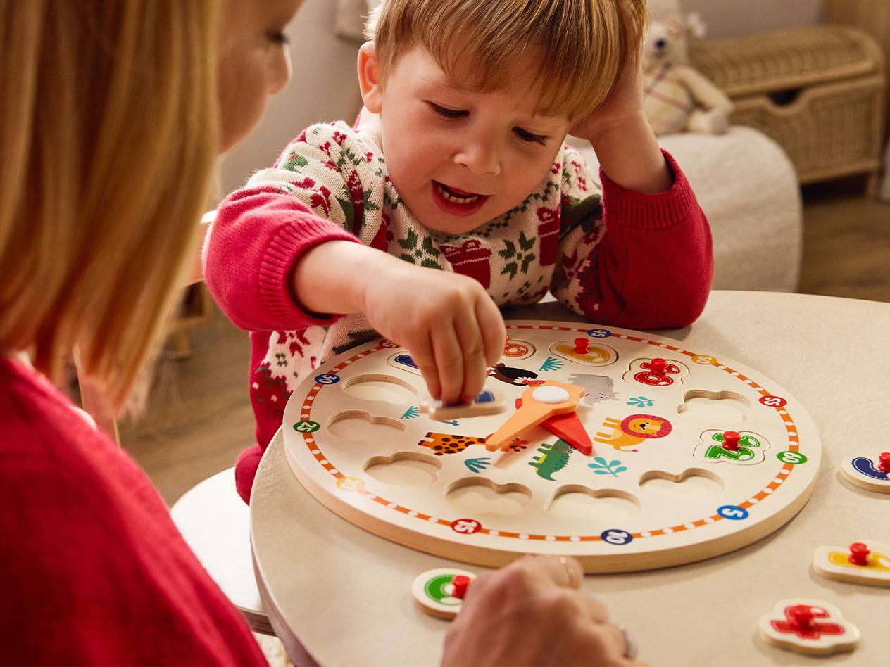 Child playing with an educational wooden animal and number puzzle.