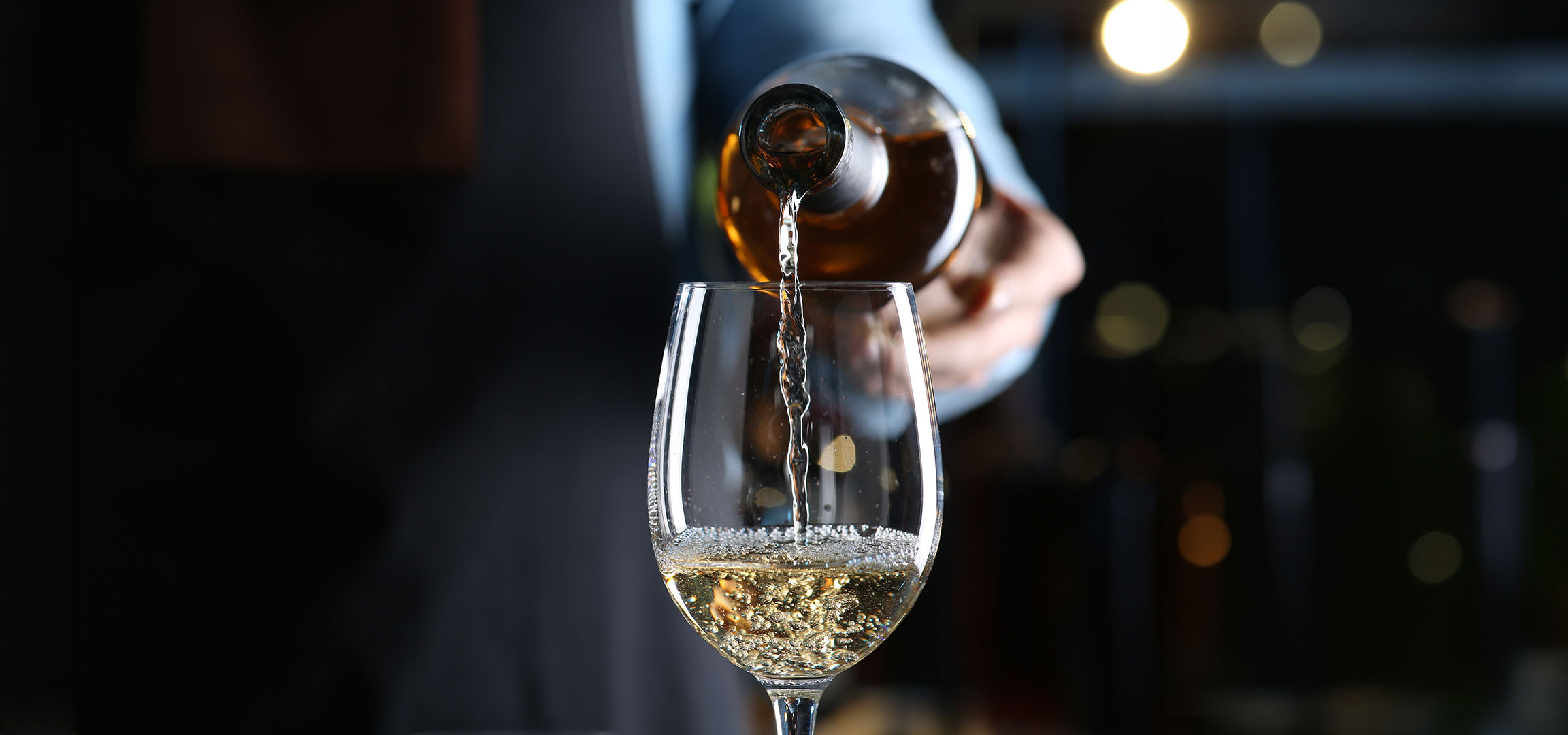 White wine being poured into a glass.