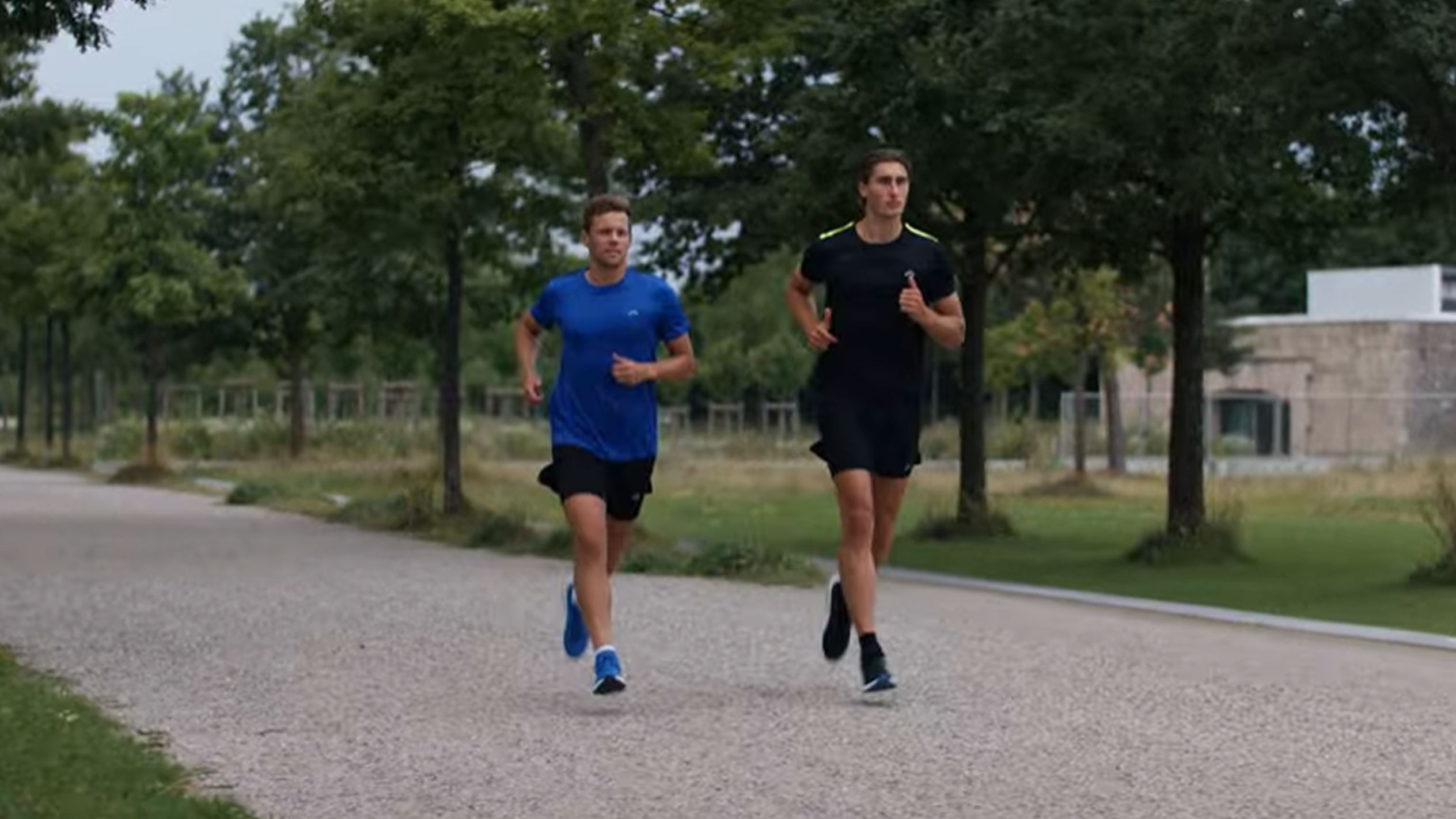 Two men running in sports t-shirts and shorts