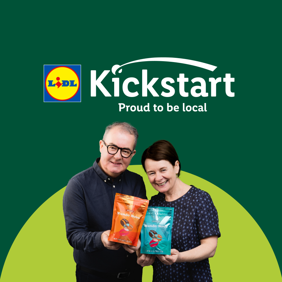 Two smiling people holding coffee bags, with a green background and 'Kickstart: Proud to be local' text.