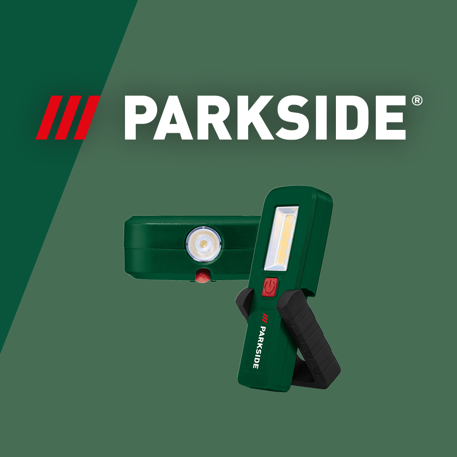 Two green work lights with bright LEDs, one standing upright and one lying down.