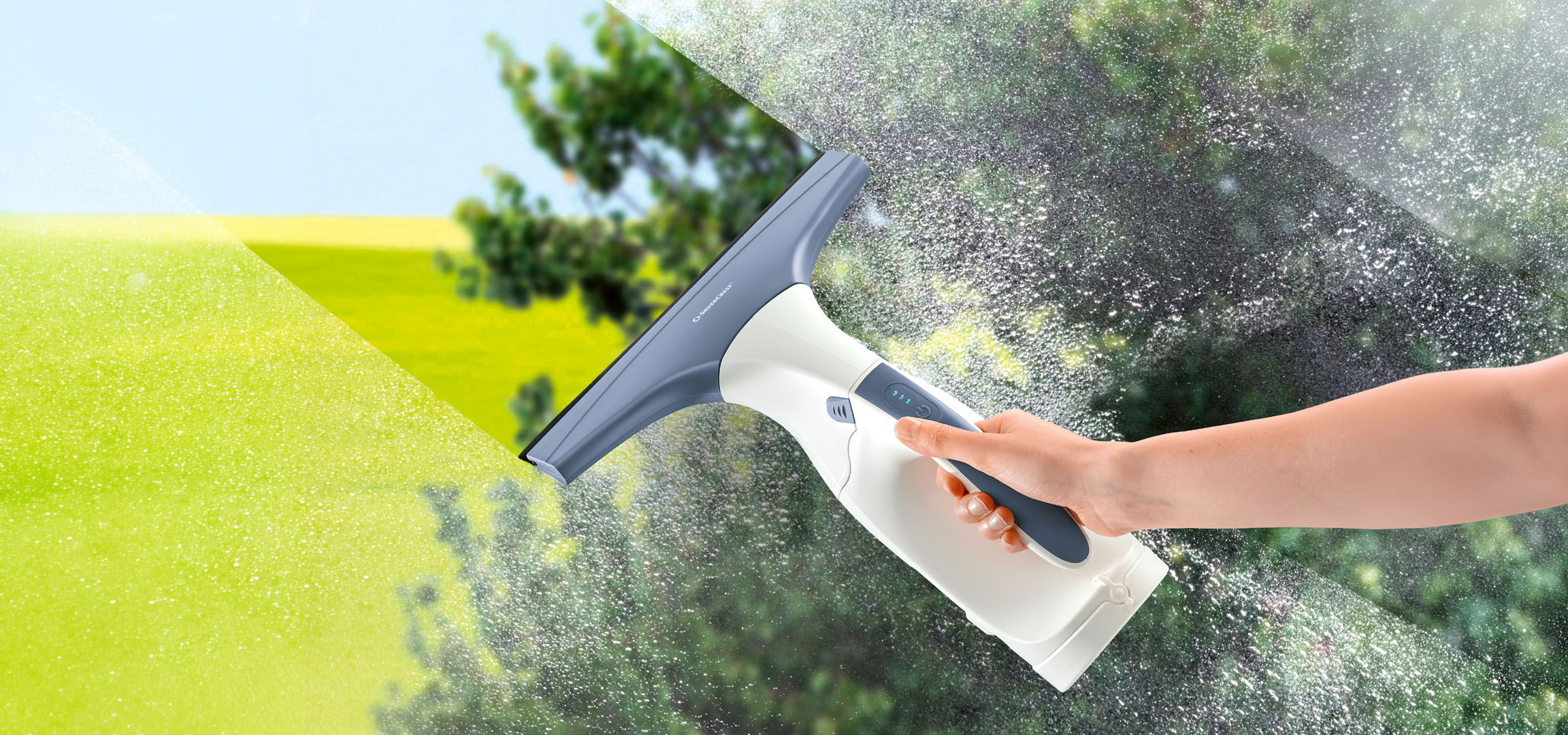 Hand cleaning a dirty window with an electric window vacuum.