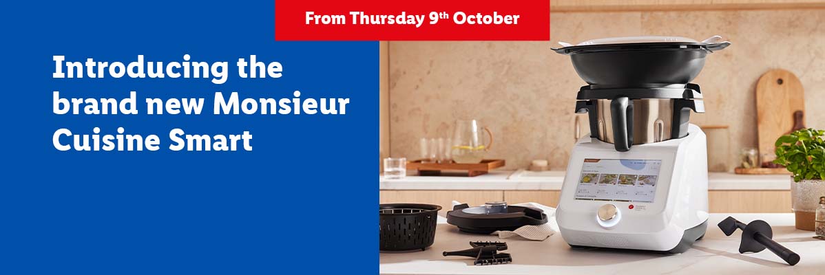 A white Monsieur Cuisine Smart food processor on a kitchen counter with text announcing its launch.