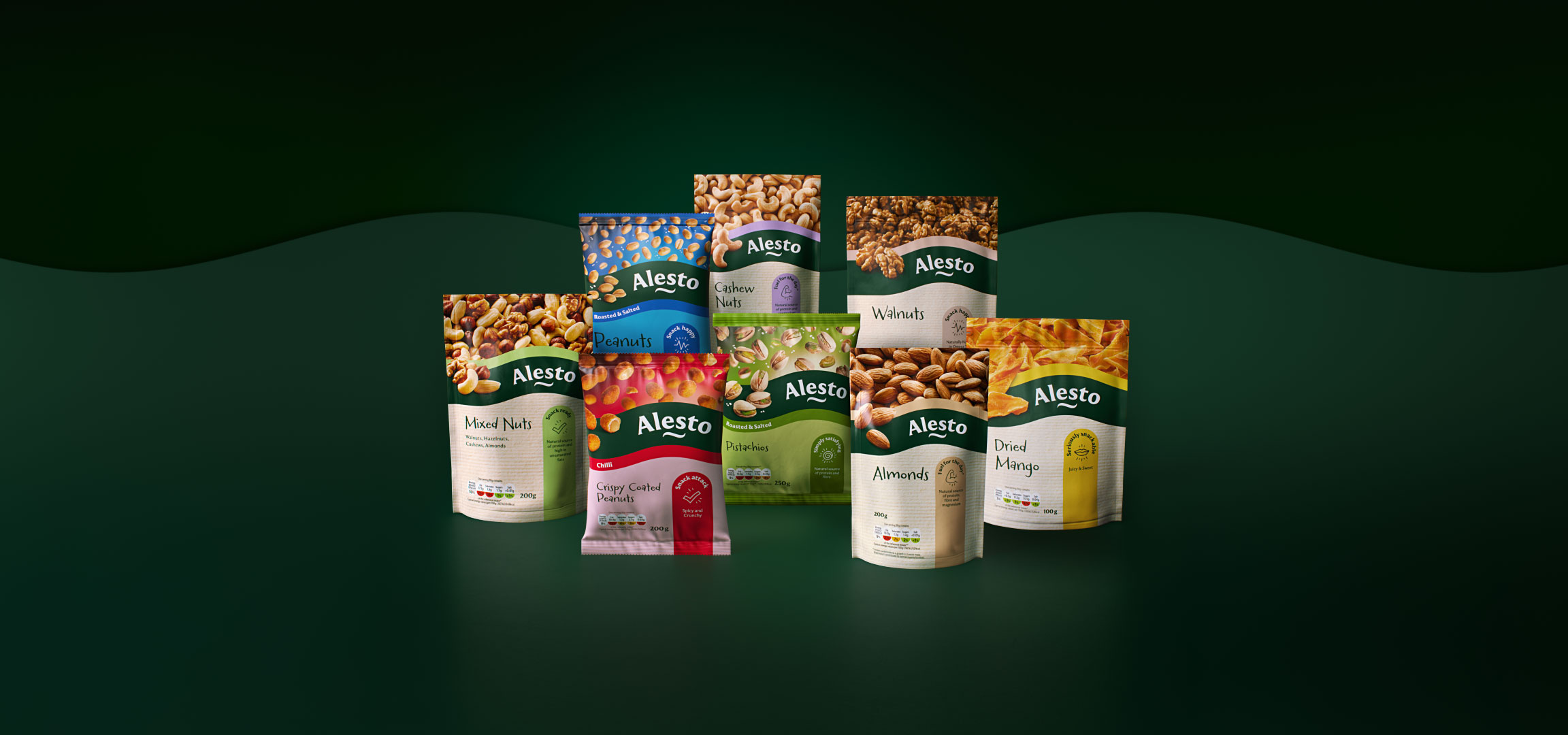 A variety of nut and dried fruit bags, including peanuts, mixed nuts, walnuts, almonds, pistachios, and dried mango, arranged on a dark green background.